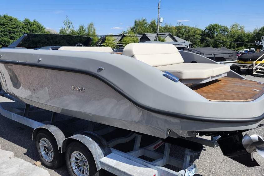 2022 Rand 25 SPIRIT boat on trailer, sleek design, gray exterior, sunny day.