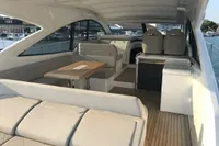 2018 Fairline Targa 48 Open yacht interior with seating and wooden table.