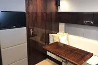Interior of 2018 Fairline Targa 48 Open yacht with wood table and seating area.