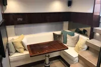 2018 Fairline Targa 48 Open interior with elegant seating and wooden table.
