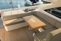2018 Fairline Targa 48 Open yacht with elegant outdoor seating and wooden table.
