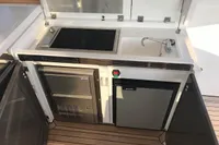 Outdoor kitchen on 2018 Fairline Targa 48 Open yacht with grill, sink, and fridge.