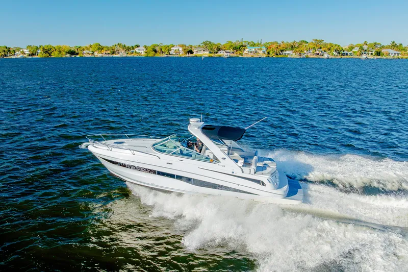 Sol Mates Yacht Photos Pics 2013 Sea Ray 370 Venture cruising on a sunny day, with scenic shoreline in the background.