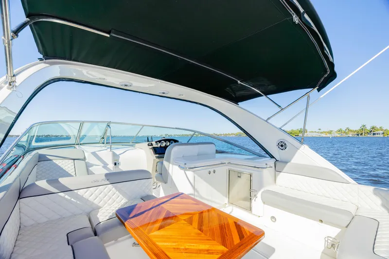 Sol Mates Yacht Photos Pics 2013 Sea Ray 370 Venture yacht interior with seating and table on a sunny day.