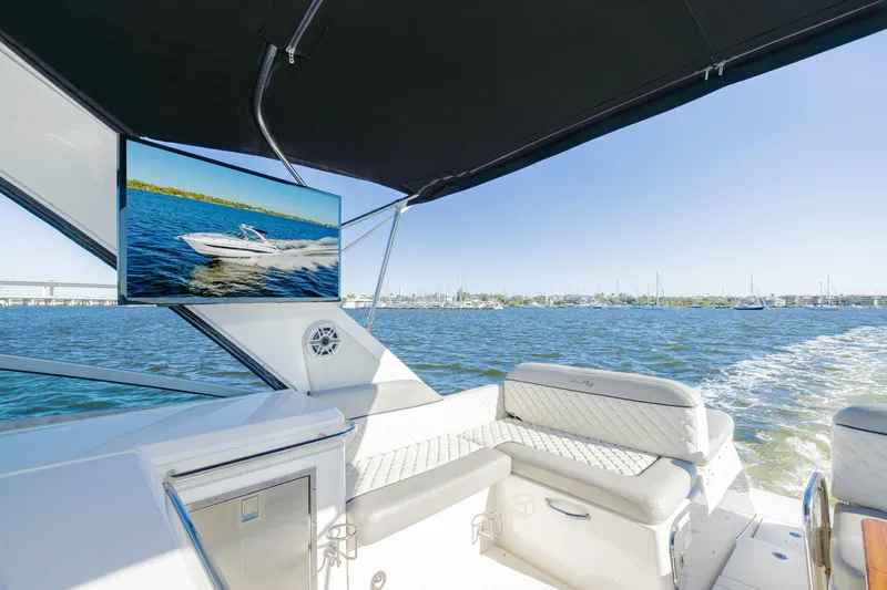 Sol Mates Yacht Photos Pics 2013 Sea Ray 370 Venture boat interior with TV, luxurious seating, and ocean view.
