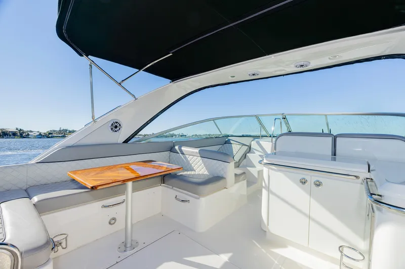 Sol Mates Yacht Photos Pics 2013 Sea Ray 370 Venture boat interior with seating and table, under a canopy.