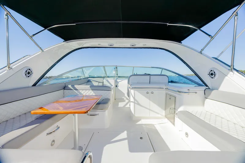 Sol Mates Yacht Photos Pics Interior of 2013 Sea Ray 370 Venture yacht with seating and table under canopy.