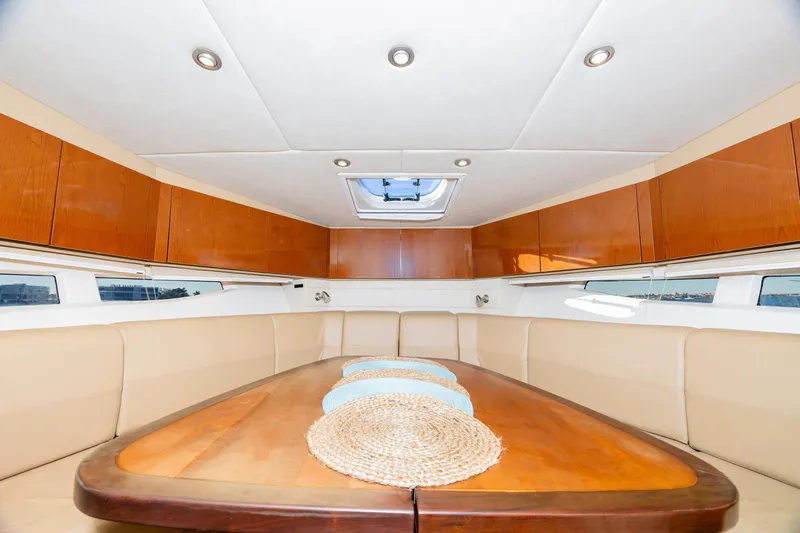 Sol Mates Yacht Photos Pics Interior of 2013 Sea Ray 370 Venture yacht with elegant dining area and wooden cabinetry.
