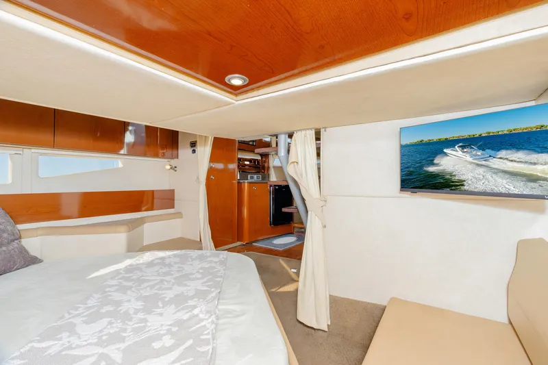 Sol Mates Yacht Photos Pics Luxurious interior of 2013 Sea Ray 370 Venture yacht with cozy bed and modern amenities.