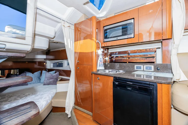 Sol Mates Yacht Photos Pics 2013 Sea Ray 370 Venture cabin interior with kitchenette, bed, and modern amenities.