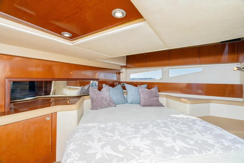 Sol Mates Yacht Photos Pics Luxurious interior of 2013 Sea Ray 370 Venture yacht with elegant bedding and wood finishes.