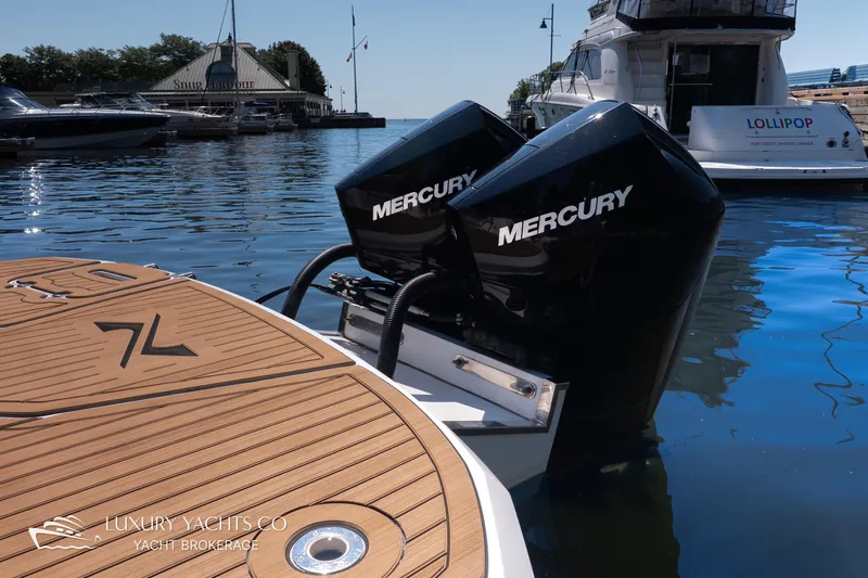  Yacht Photos Pics 2024 NX 280 Xtreme yacht with dual Mercury engines docked at a marina.