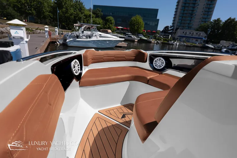  Yacht Photos Pics 2024 NX 280 Xtreme luxury yacht interior with brown seating and waterfront view.