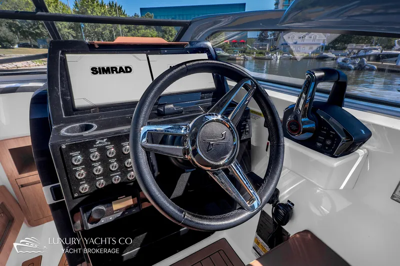  Yacht Photos Pics 2024 NX 280 Xtreme yacht cockpit with steering wheel and Simrad navigation system.
