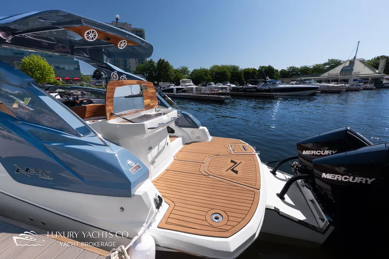  Yacht Photos Pics 2024 NX 280 Xtreme luxury yacht docked with Mercury engines, featuring sleek design and spacious deck.