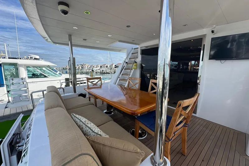  Yacht Photos Pics 2003 Hargrave Open Bridge yacht deck with dining area and marina view.