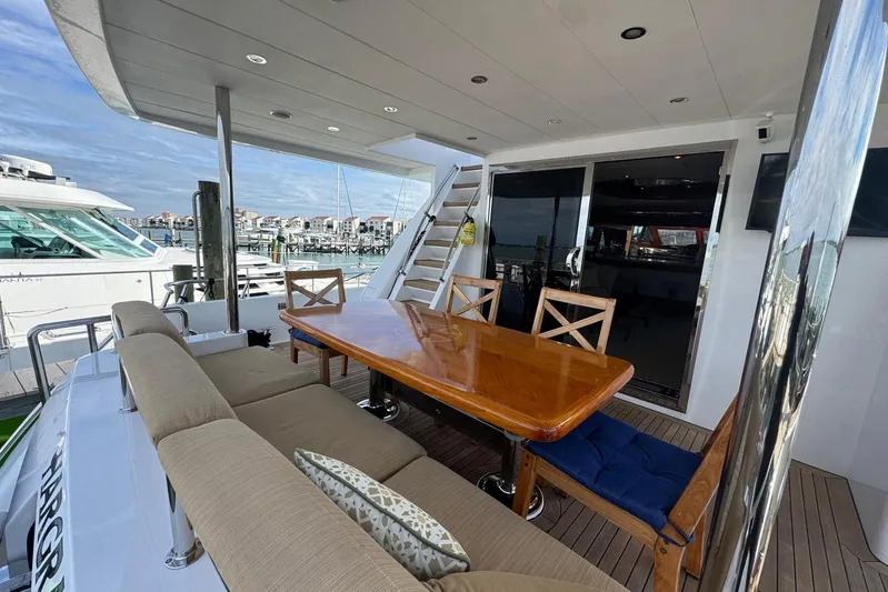  Yacht Photos Pics Luxurious 2003 Hargrave Open Bridge yacht with elegant outdoor dining area.