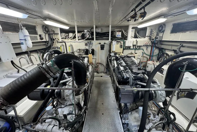  Yacht Photos Pics Engine room of a 2003 Hargrave Open Bridge yacht, featuring dual engines and mechanical systems.