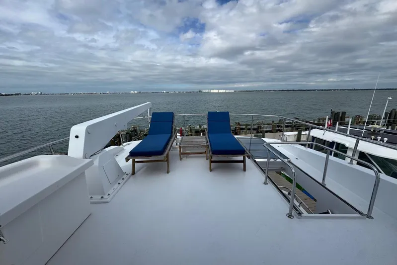  Yacht Photos Pics 2003 Hargrave Open Bridge yacht deck with blue lounge chairs and ocean view.