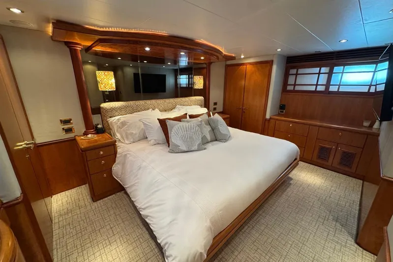  Yacht Photos Pics Luxurious bedroom interior on a 2003 Hargrave Open Bridge yacht, featuring elegant wood finishes.