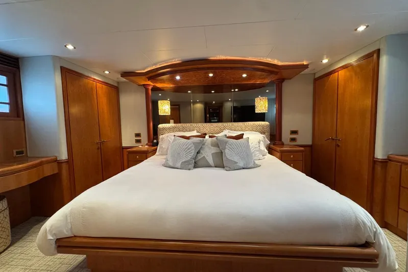  Yacht Photos Pics Luxurious bedroom interior on a 2003 Hargrave Open Bridge yacht, featuring elegant wood finishes.
