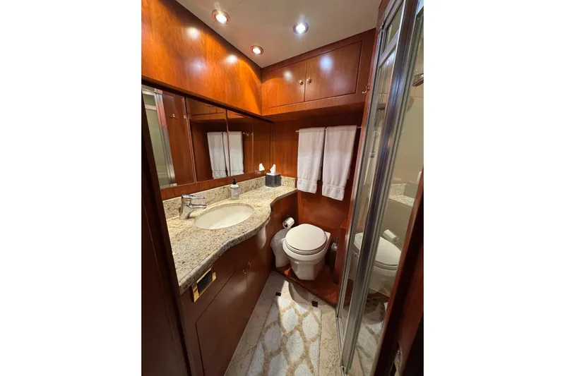  Yacht Photos Pics Luxurious 2003 Hargrave Open Bridge yacht bathroom with wood cabinetry and granite countertop.