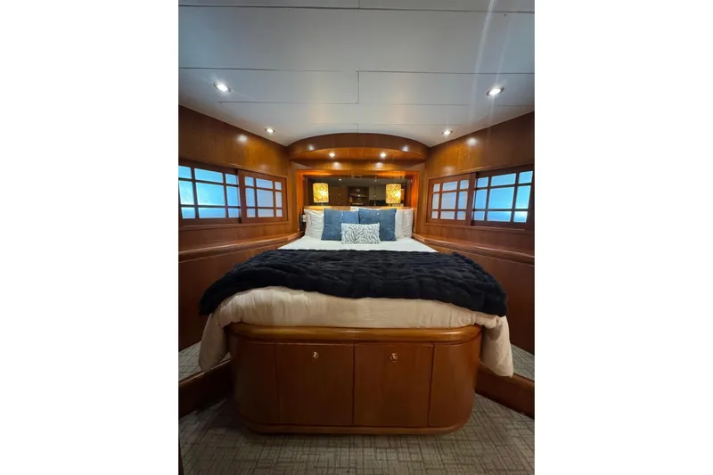  Yacht Photos Pics Luxurious bedroom interior on 2003 Hargrave Open Bridge yacht with elegant wood paneling.