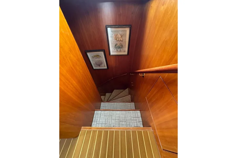  Yacht Photos Pics Staircase with wooden walls and framed art in 2003 Hargrave Open Bridge yacht.