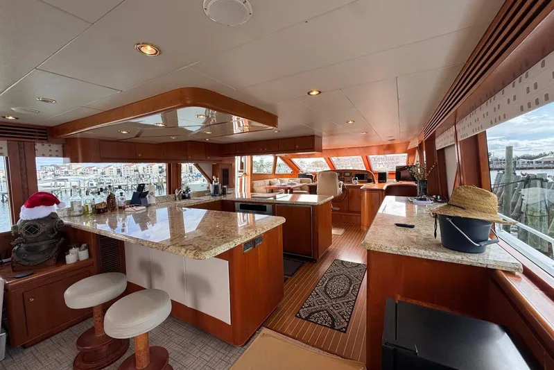  Yacht Photos Pics Luxurious interior of 2003 Hargrave Open Bridge yacht with elegant wood and granite finishes.
