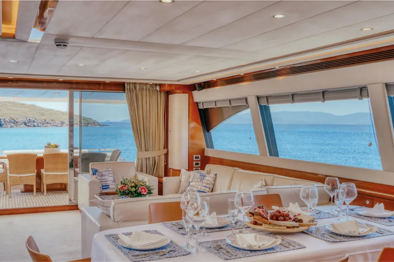  Yacht Photos Pics Luxurious interior of 2006 Ferretti Yachts 830 with ocean view and elegant dining setup.