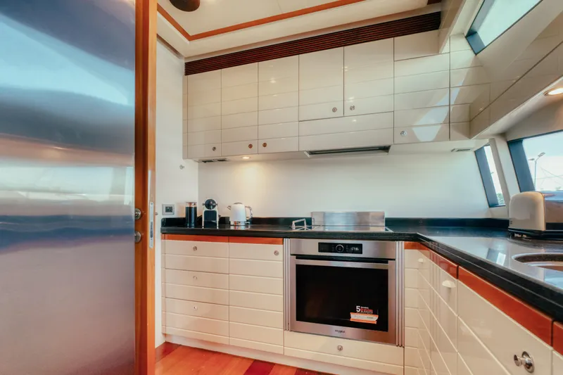  Yacht Photos Pics Luxurious kitchen interior of 2006 Ferretti Yachts 830 with modern appliances and sleek design.