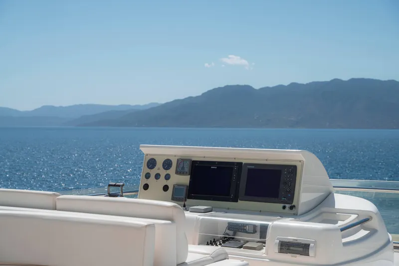  Yacht Photos Pics Helm of 2006 Ferretti Yachts 830 overlooking serene ocean and distant mountains.