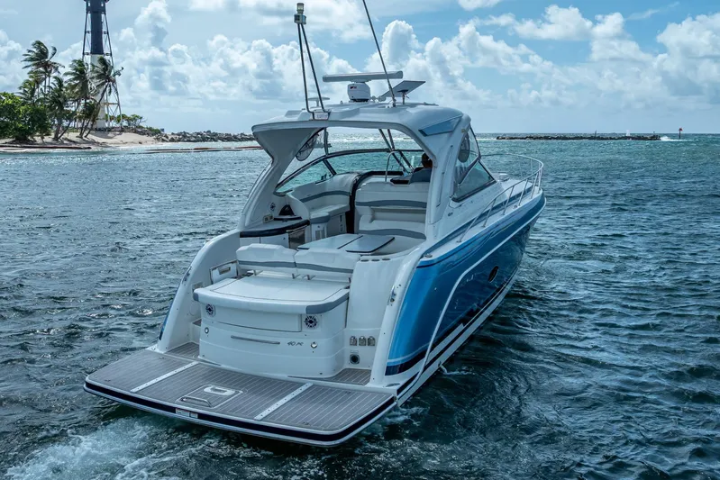  Yacht Photos Pics 2022 Formula 40 Performance Cruiser on ocean near tropical island and lighthouse.