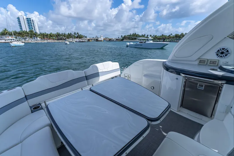  Yacht Photos Pics 2022 Formula 40 Performance Cruiser, luxurious deck view, docked near palm-lined shore.