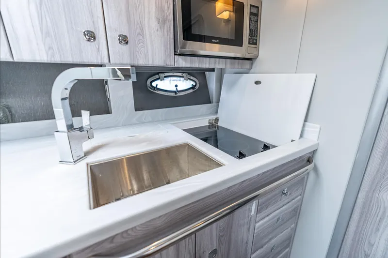  Yacht Photos Pics Modern kitchen in 2022 Formula 40 Performance Cruiser with sink, stove, and microwave.