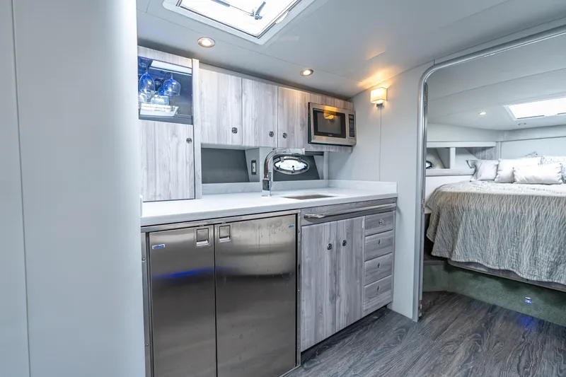  Yacht Photos Pics 2022 Formula 40 Performance Cruiser interior with modern kitchen and cozy bedroom.