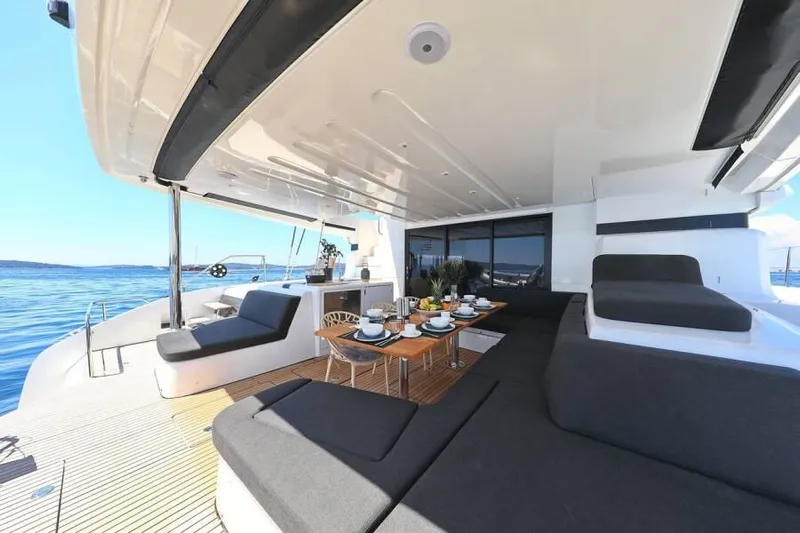  Yacht Photos Pics Luxurious 2023 Lagoon 55 yacht deck with dining area and ocean view.