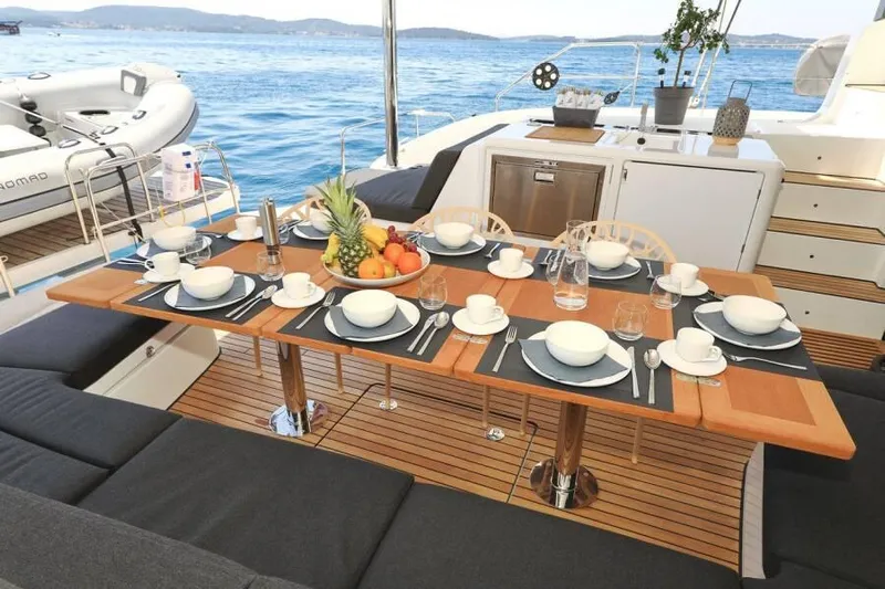  Yacht Photos Pics Luxurious Lagoon 55 yacht dining area with elegant table setting, 2023 model.