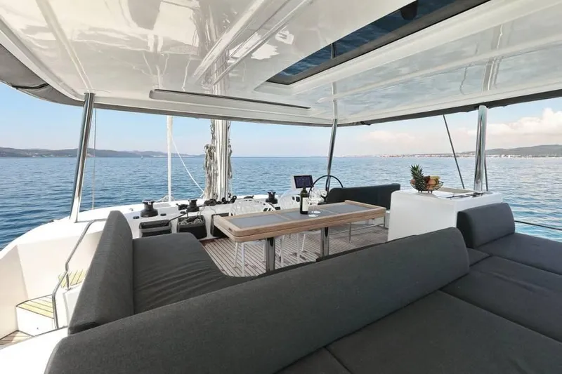  Yacht Photos Pics Luxurious 2023 Lagoon 55 yacht interior with modern seating and ocean view.