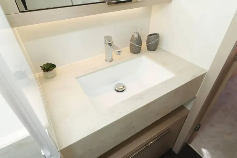 Yacht Photos Pics Modern bathroom sink on Lagoon 55 yacht, 2023 model, with sleek faucet and decor.
