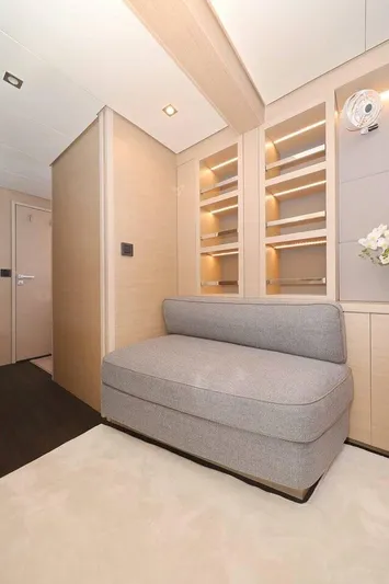  Yacht Photos Pics Modern interior of 2023 Lagoon 55 yacht with cozy seating and elegant shelving.