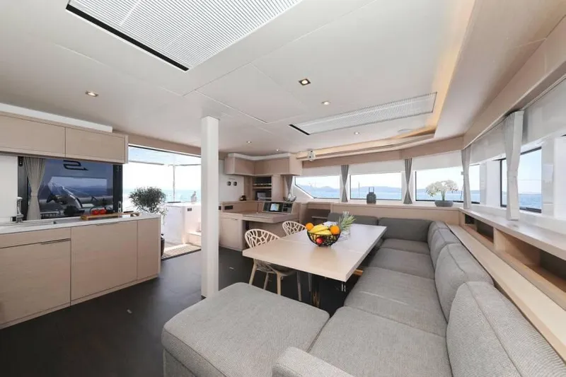  Yacht Photos Pics Luxurious interior of 2023 Lagoon 55 yacht with modern kitchen and spacious seating area.
