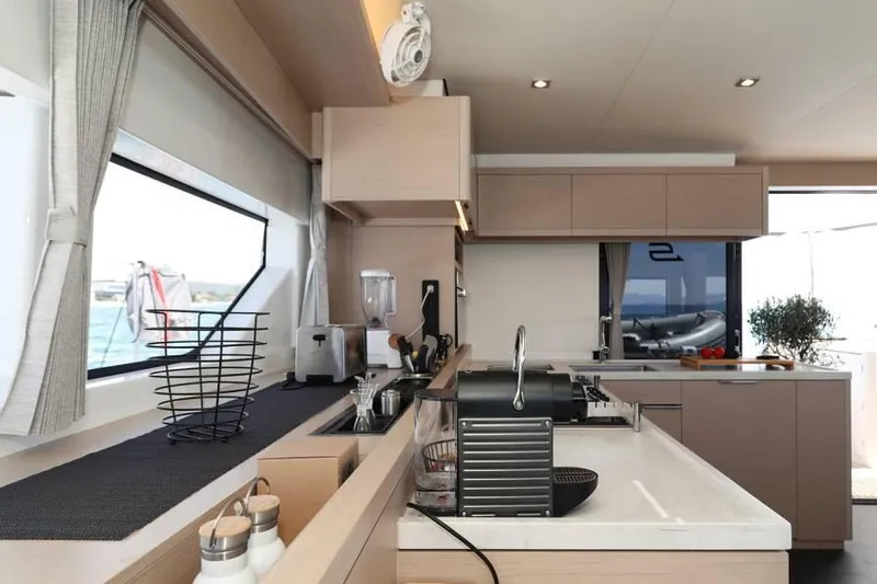  Yacht Photos Pics Modern kitchen interior on 2023 Lagoon 55 yacht, featuring sleek design and ocean view.