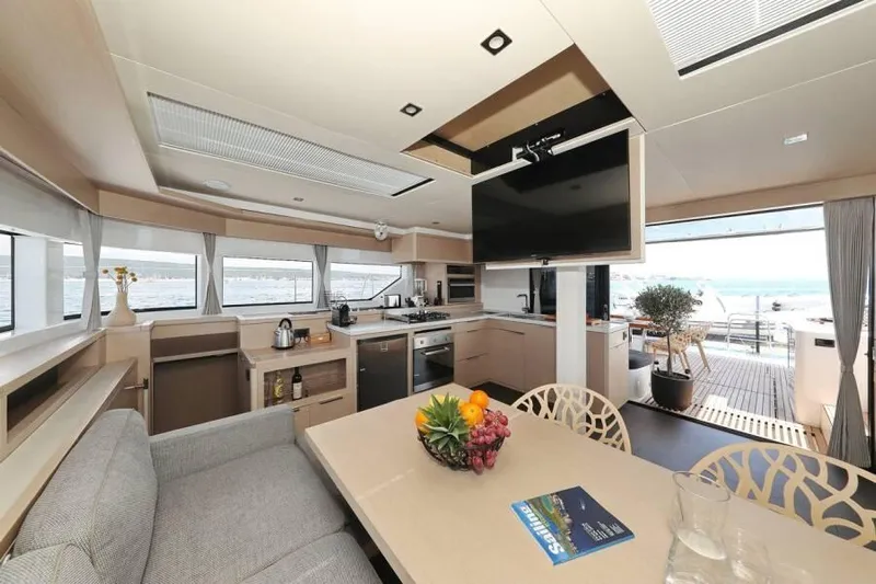  Yacht Photos Pics Luxurious interior of 2023 Lagoon 55 yacht with modern kitchen and dining area.