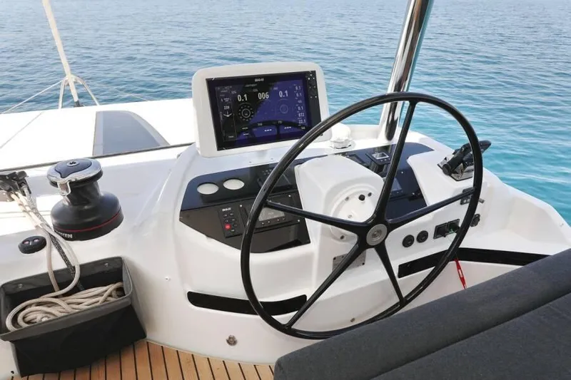  Yacht Photos Pics Helm of 2023 Lagoon 55 yacht with navigation display and steering wheel.