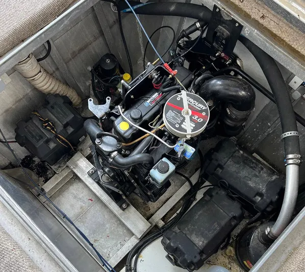 Stock Options Yacht Photos Pics Engine compartment of a 2000 Stardust Cruisers 6816 houseboat, featuring a Mercury 3.0 motor.