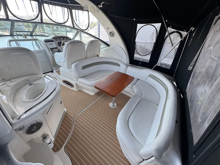 Finalize Yacht Photos Pics 2007 Sea Ray 340 Sundancer interior with white seating, wooden table, and helm station.