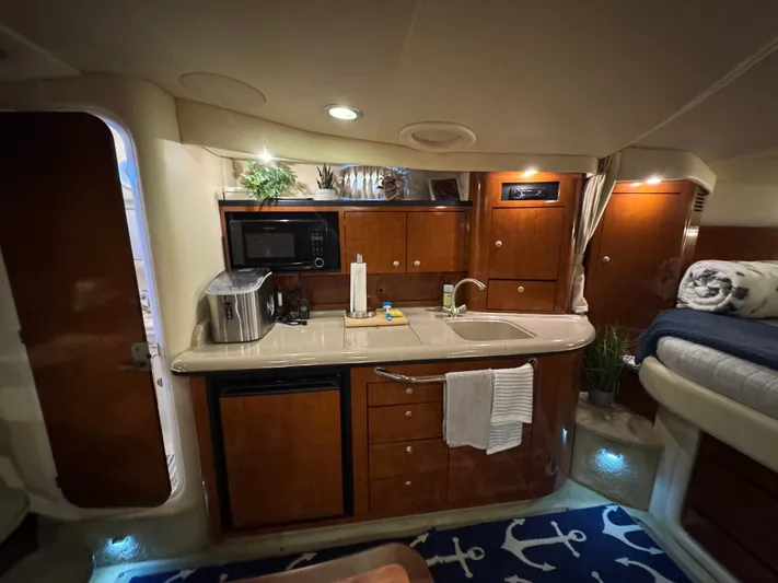 Finalize Yacht Photos Pics Interior of 2007 Sea Ray 340 Sundancer yacht with kitchenette and cozy sleeping area.