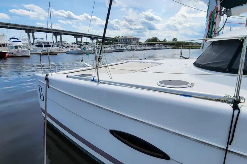 Benevah Yacht Photos Pics 2013 Fountaine Pajot Lipari 41 catamaran docked in a marina with bridge in background.