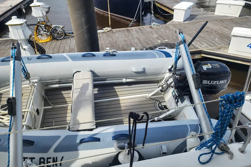 Benevah Yacht Photos Pics Inflatable boat with Suzuki motor docked near a Fountaine Pajot Lipari 41, 2013 model.